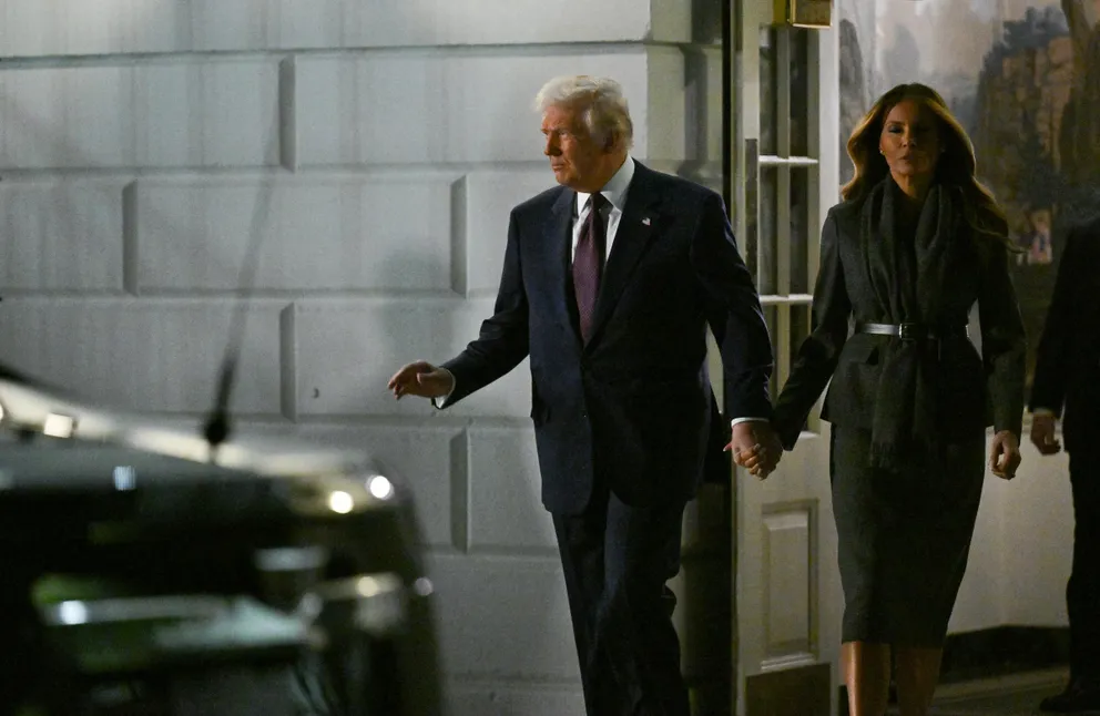 Donald and Melania Trump holding hands as they exited the White House. | Source: Getty Images